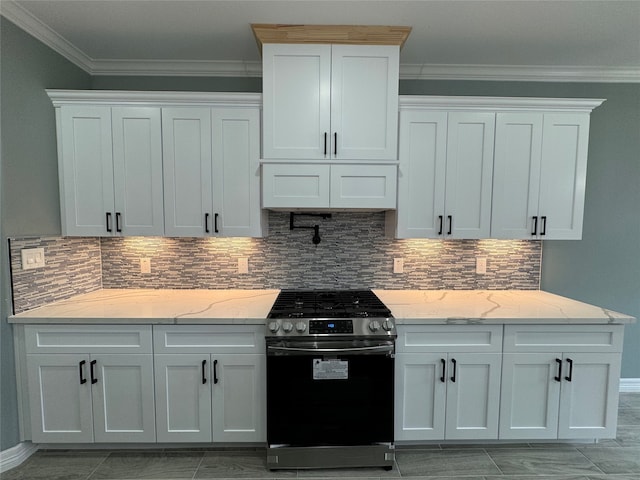 kitchen featuring white cabinets, stainless steel stove, and light stone counters