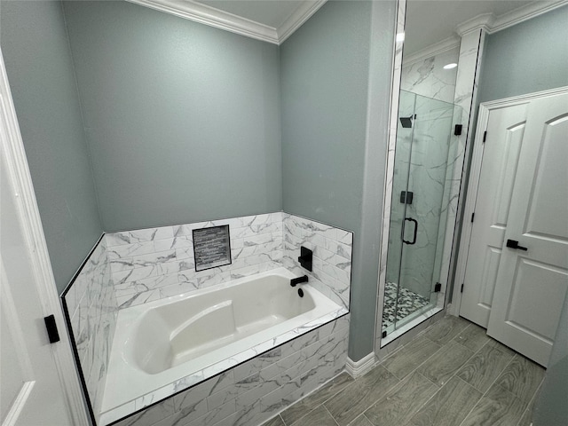 bathroom featuring ornamental molding, shower with separate bathtub, and wood-type flooring