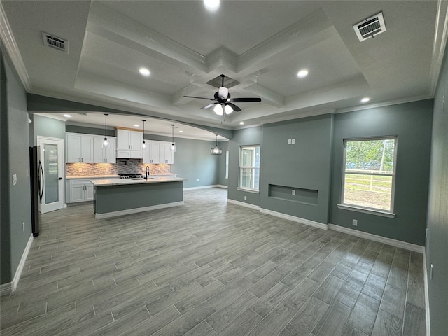 kitchen featuring decorative light fixtures, stainless steel refrigerator, light hardwood / wood-style floors, white cabinets, and ceiling fan