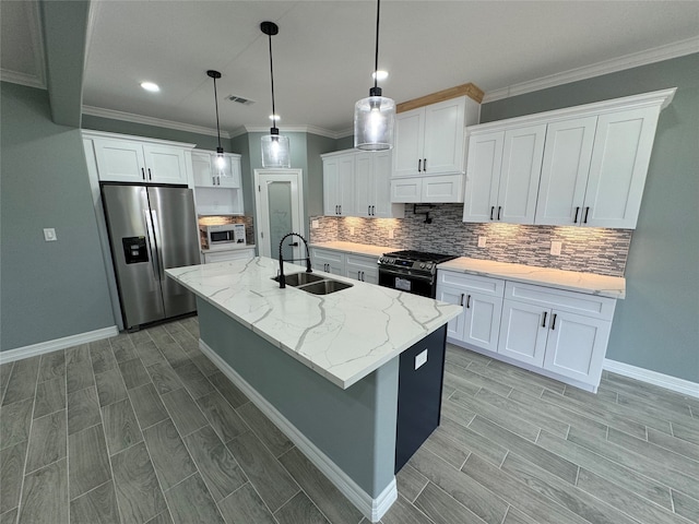 kitchen featuring white cabinets, stainless steel fridge, sink, and black gas range oven