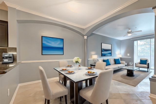 tiled dining area featuring ceiling fan, crown molding, and decorative columns