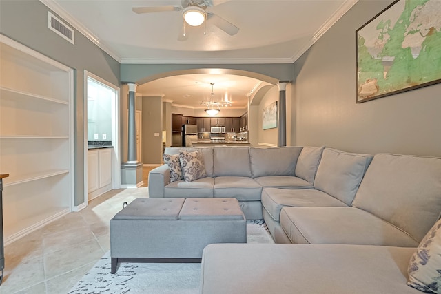 tiled living room with ceiling fan, ornamental molding, and decorative columns