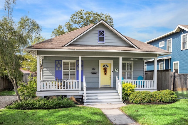 bungalow with a front yard and a porch