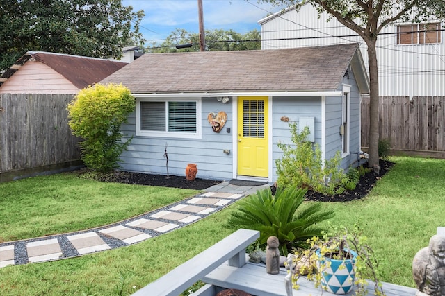 view of front facade with a front lawn and a shed