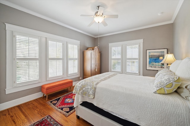 bedroom with ornamental molding, wood-type flooring, and ceiling fan