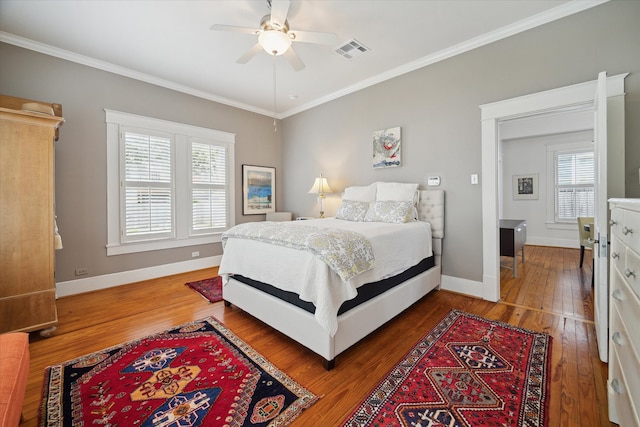 bedroom with multiple windows, crown molding, ceiling fan, and dark hardwood / wood-style floors