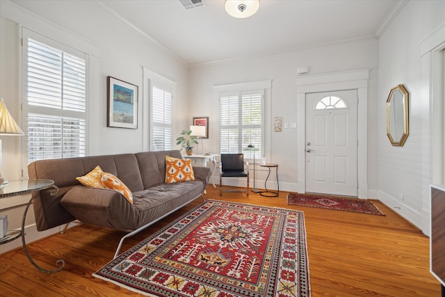 living room featuring hardwood / wood-style flooring and crown molding