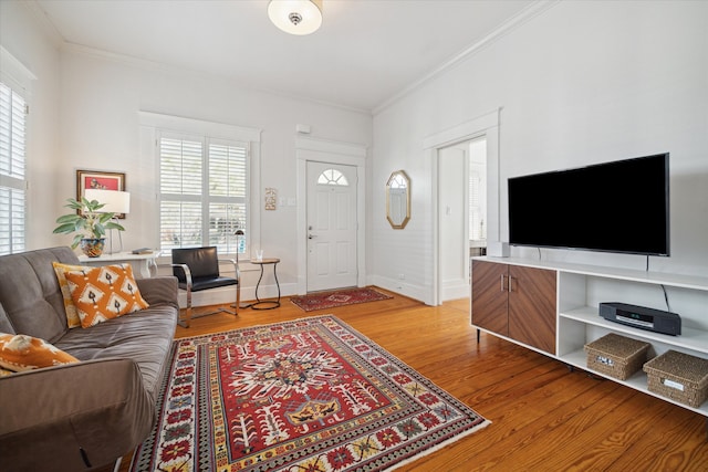 living room with ornamental molding and hardwood / wood-style floors