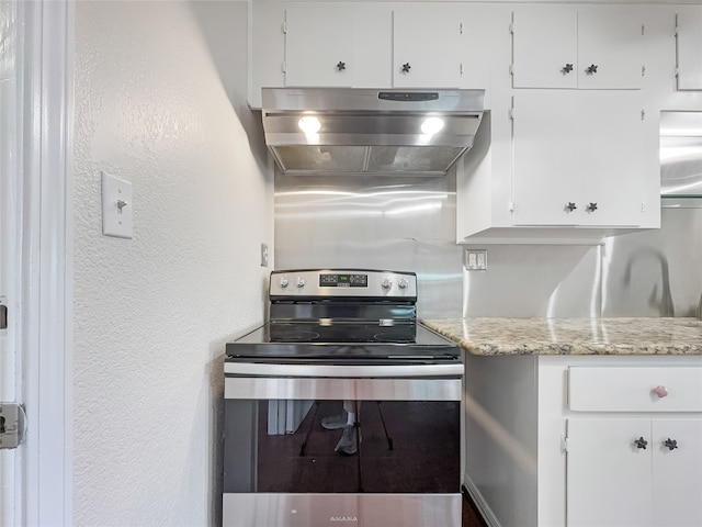 kitchen featuring white cabinetry, stainless steel electric range oven, extractor fan, and light stone counters