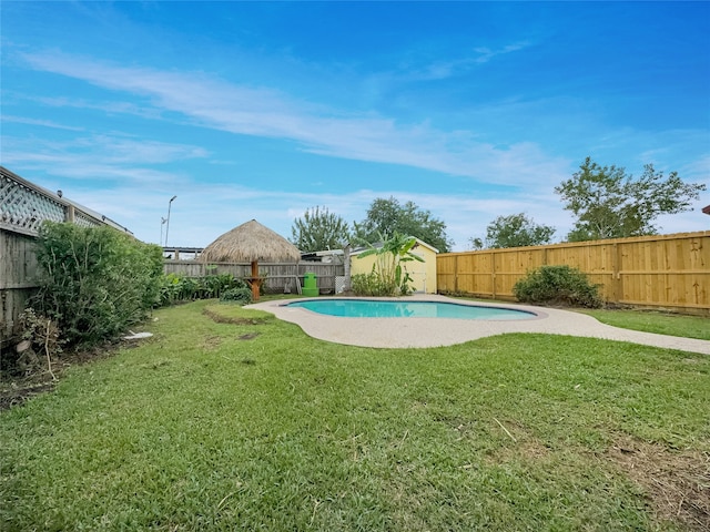 view of pool featuring a yard