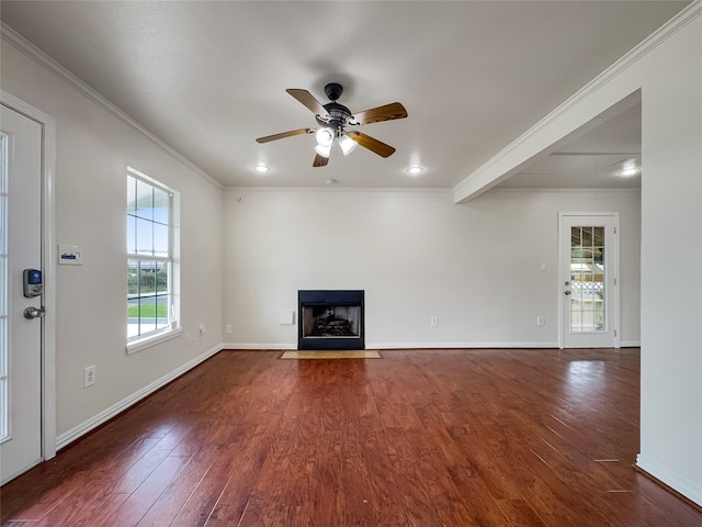 unfurnished living room with ornamental molding, plenty of natural light, ceiling fan, and dark hardwood / wood-style flooring