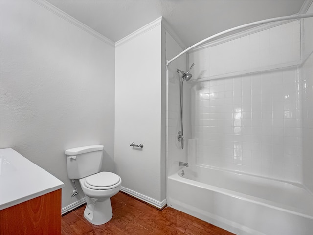 full bathroom with toilet, hardwood / wood-style flooring, tiled shower / bath combo, vanity, and crown molding