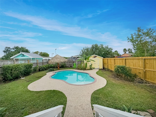 view of pool with a shed, a lawn, and a patio area