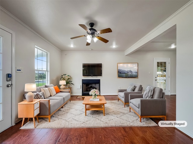 living room featuring light wood-type flooring, beamed ceiling, crown molding, and ceiling fan