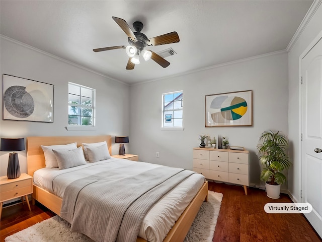 bedroom with dark hardwood / wood-style flooring, ornamental molding, and ceiling fan