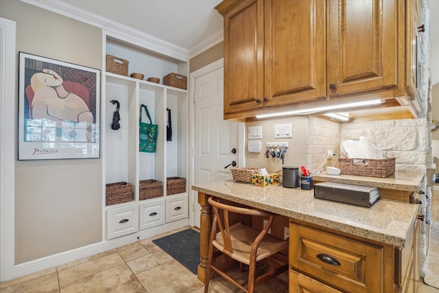 mudroom featuring crown molding and light tile patterned flooring