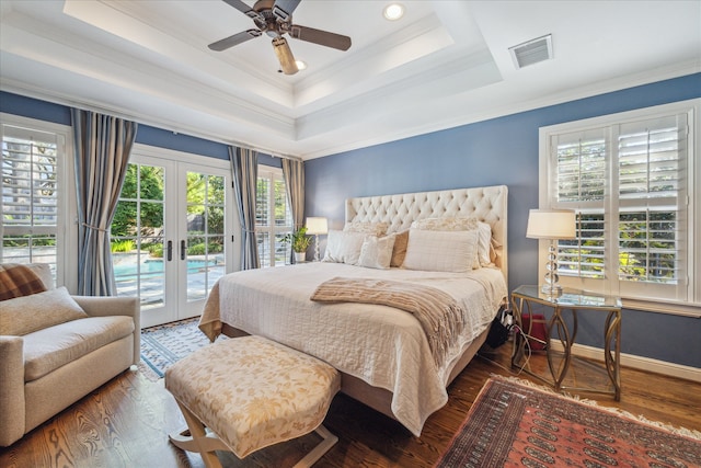 bedroom with dark hardwood / wood-style flooring, multiple windows, and french doors