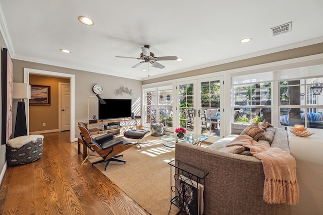 living room with crown molding, french doors, ceiling fan, and wood-type flooring