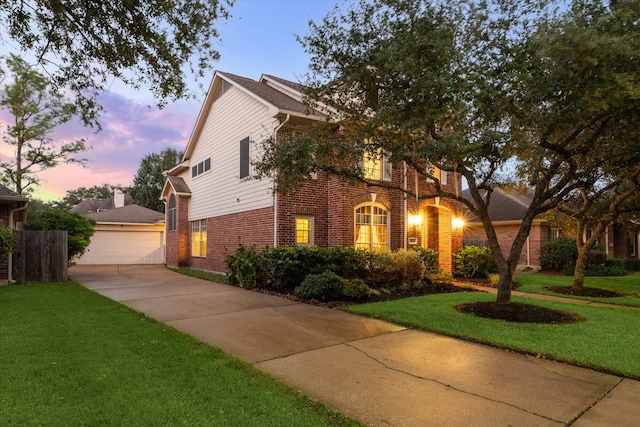 view of front facade with a lawn and a garage