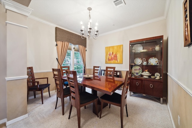 dining area with ornamental molding and a notable chandelier
