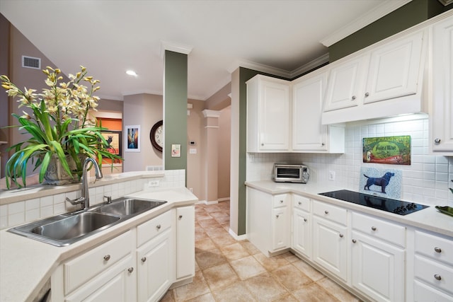 kitchen with white cabinetry, sink, tasteful backsplash, crown molding, and black electric stovetop