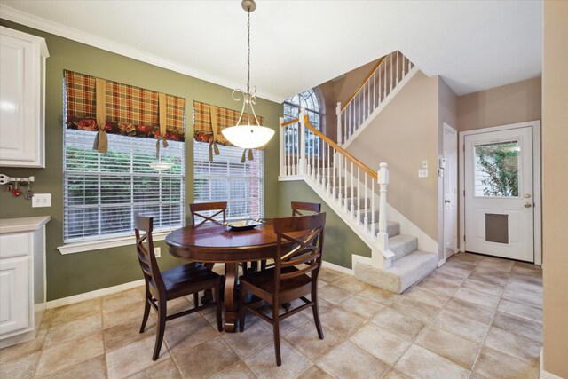 dining room with ornamental molding and a wealth of natural light