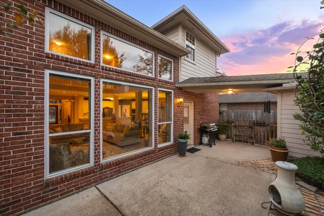 patio terrace at dusk with a grill