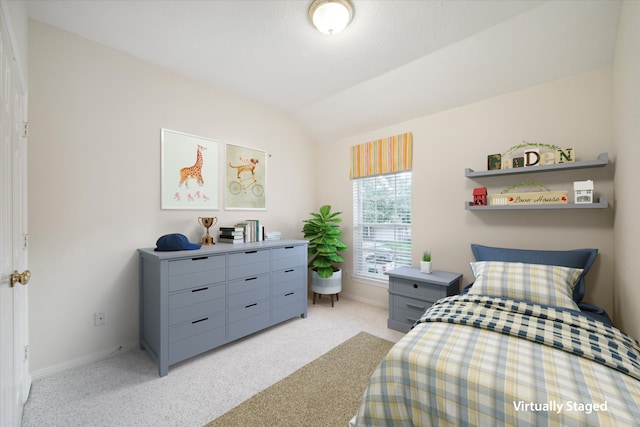carpeted bedroom with vaulted ceiling