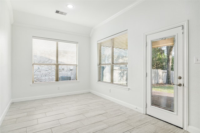 unfurnished room with plenty of natural light and ornamental molding