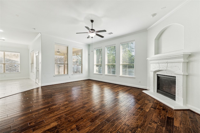 unfurnished living room with ceiling fan, dark hardwood / wood-style floors, and ornamental molding