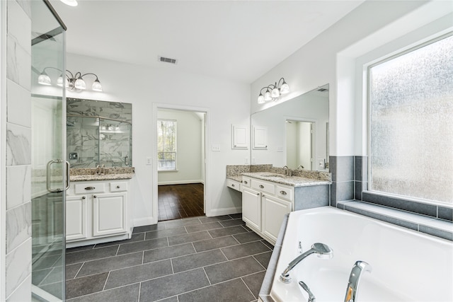 bathroom featuring tile patterned flooring, vanity, and separate shower and tub