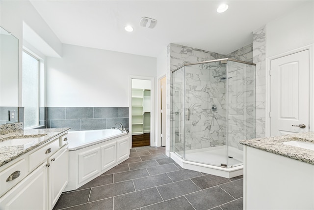 bathroom with tile patterned flooring, vanity, and shower with separate bathtub