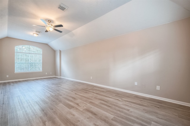 unfurnished room with ceiling fan, light hardwood / wood-style flooring, and lofted ceiling