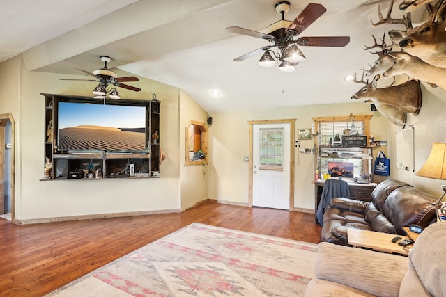 living room with lofted ceiling, hardwood / wood-style floors, and ceiling fan