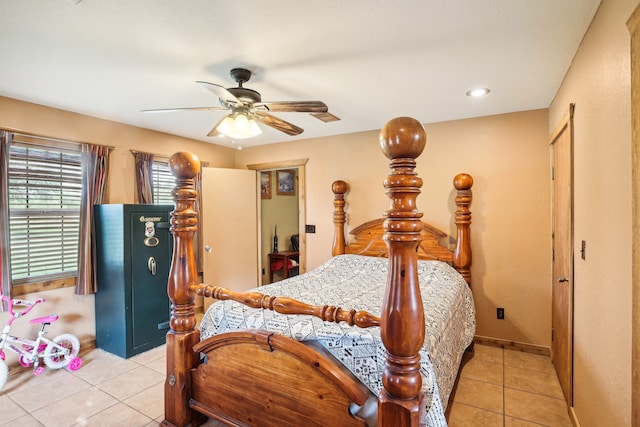 bedroom with a closet, ceiling fan, and light tile patterned flooring