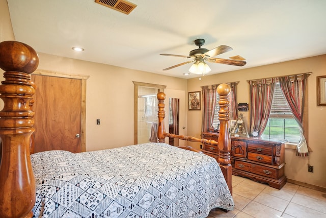 tiled bedroom featuring ceiling fan