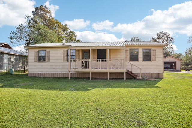 rear view of property featuring a yard