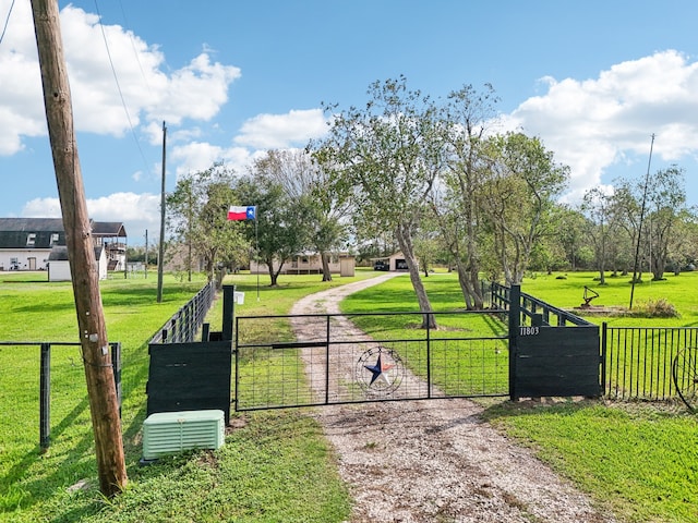 view of gate featuring a yard