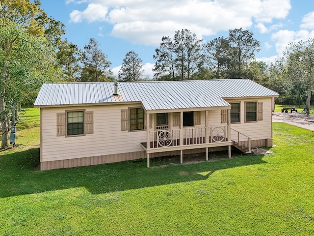 rear view of property featuring a lawn