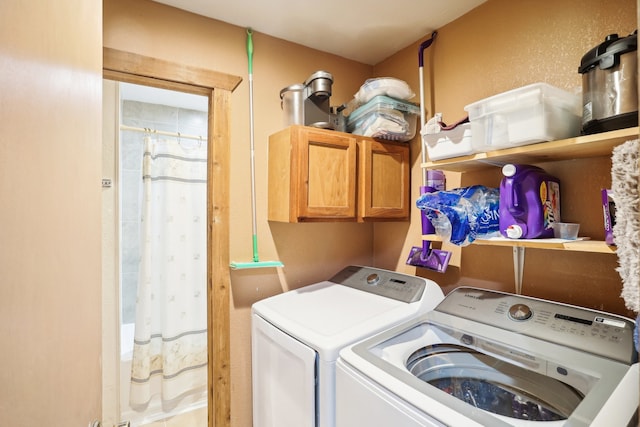 clothes washing area with cabinets and washer and dryer