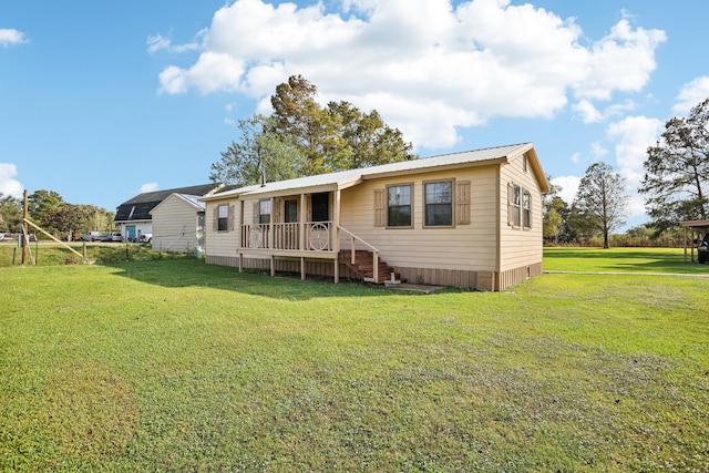 rear view of property featuring a yard