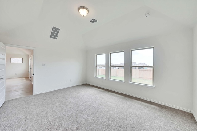 spare room featuring light colored carpet