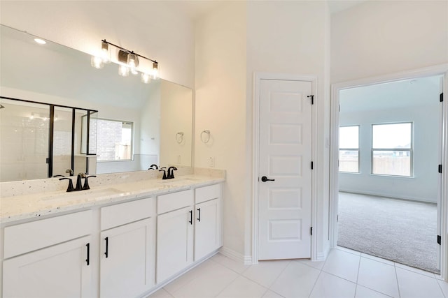 bathroom with vanity, a shower with door, and tile patterned floors