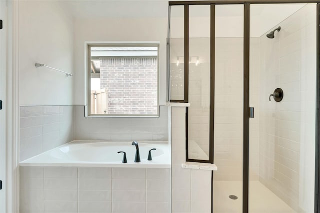 bathroom featuring separate shower and tub