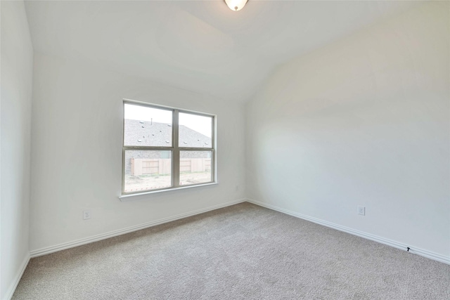 empty room featuring lofted ceiling and carpet floors