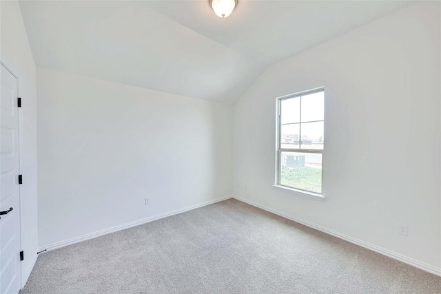 interior space featuring vaulted ceiling and carpet