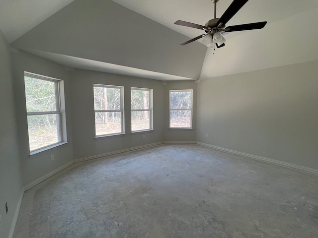 empty room featuring ceiling fan, lofted ceiling, and concrete flooring