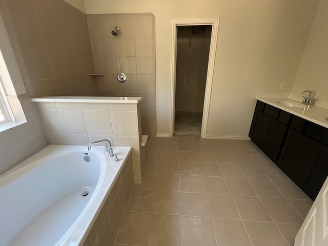 bathroom with tile patterned flooring, vanity, and separate shower and tub