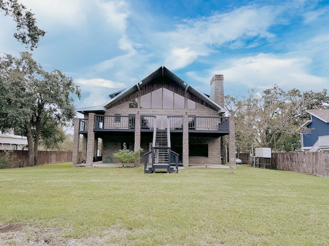 back of house with a lawn and a wooden deck