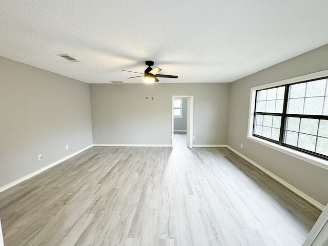 unfurnished room with light wood-type flooring, a textured ceiling, and ceiling fan